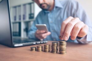 Finances and budgeting, businessman stacking coins